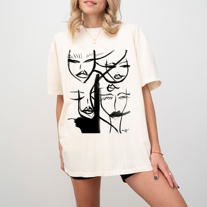 Abstract Faces T-Shirt by Printify featuring an artistic abstract face design on an ivory fabric.