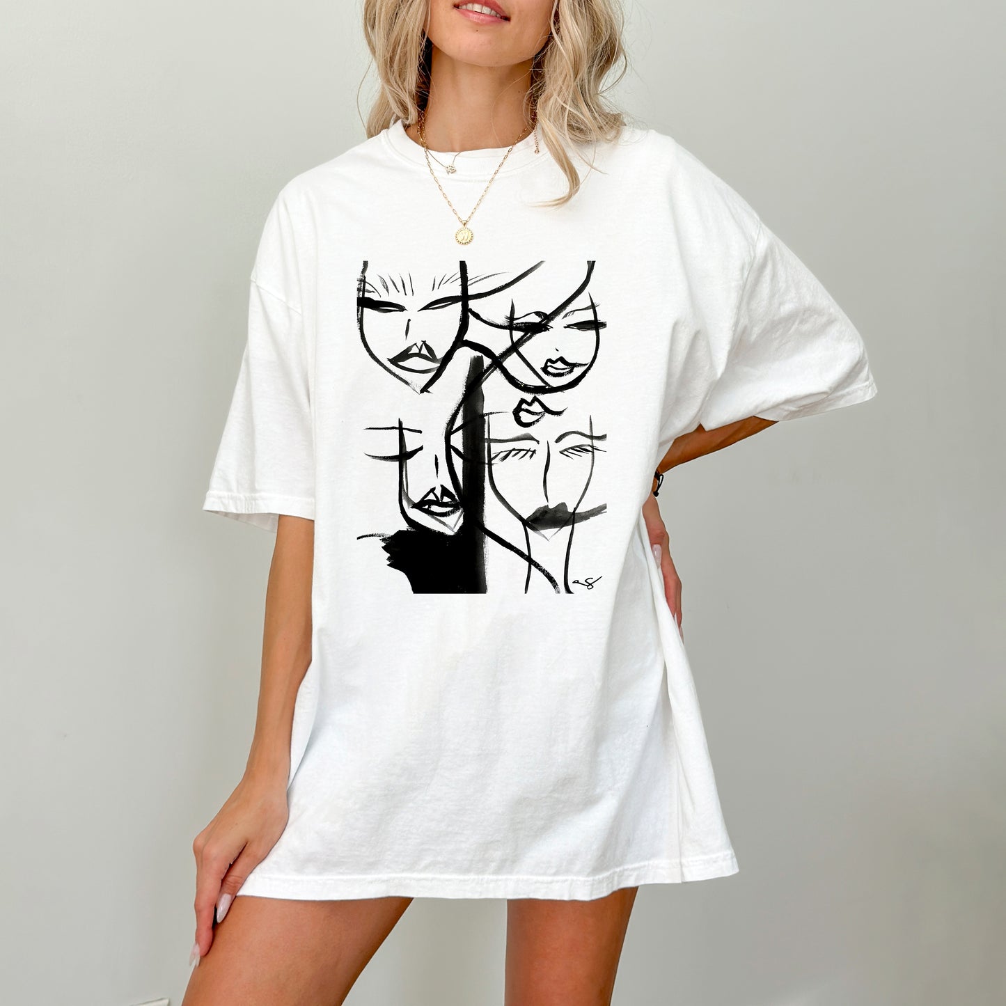 White abstract faces print t-shirt by Printify featuring artistic face illustrations on a casual cotton tee.